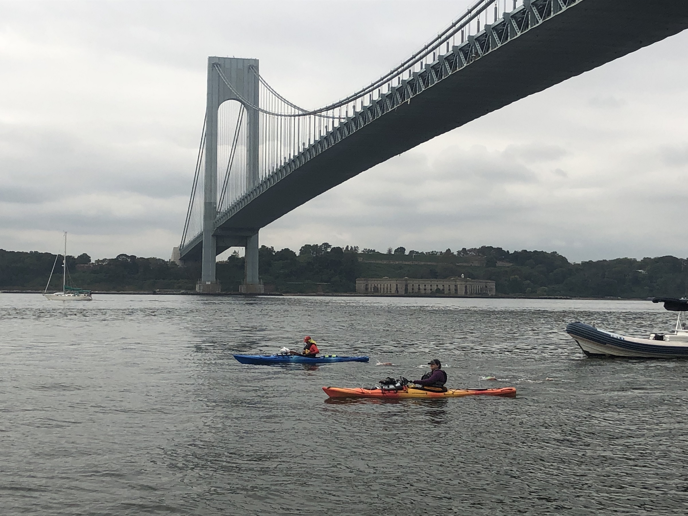 Swimmers and paddlers under the Verrazano-Narrows Bridge